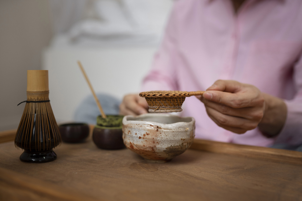 Sifting matcha powder before whisking with bamboo chasen